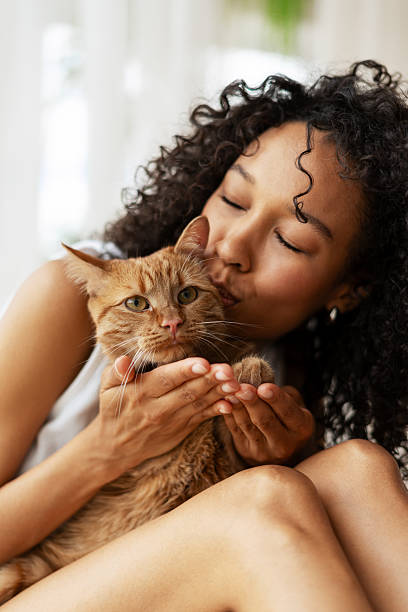 istock Young Woman Embracing Her Ginger Cat Lovingly 2227652406