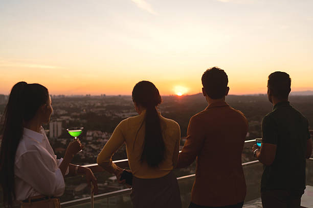 istock Asian co workers meet for cocktail after work hours 2227652555