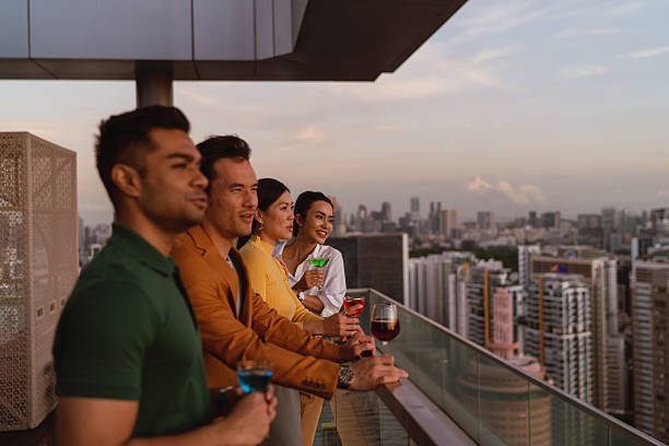 istock Diverse Asian co workers taking in the sunset view from a rooftop bar 2227652586