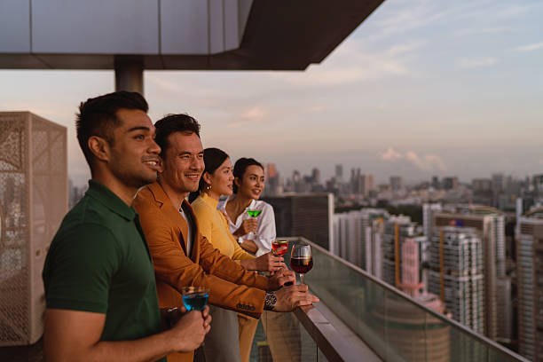 istock Diverse Asian co workers taking in the sunset view from a rooftop bar 2227652610