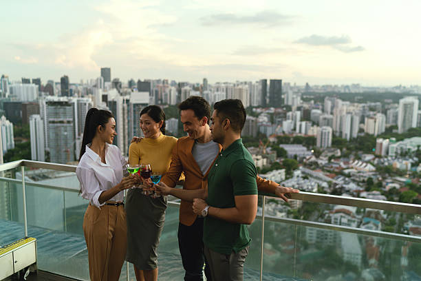 istock Asian co workers taking in the sunset view from a rooftop bar 2227652686