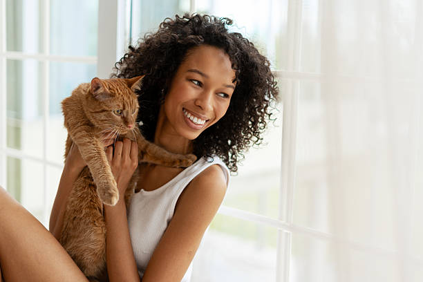 istock Smiling Young Woman Holding Pet Cat 2227652699
