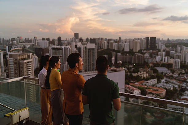 istock Asian co workers taking in the sunset view from a rooftop bar 2227652755