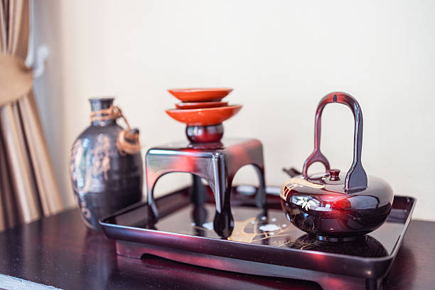 Traditional ryokan tea set in Japanese style resting on wooden table to relax and enjoy peaceful moment in calm and elegant rest environment