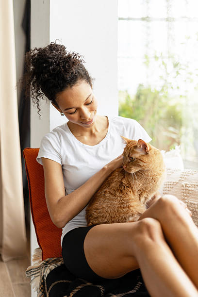 istock Young Woman Relaxing at Home with her Ginger Cat 2227652879
