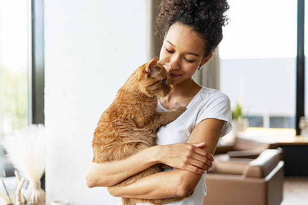 istock Young Woman Embracing her Ginger Cat at Home 2227652882