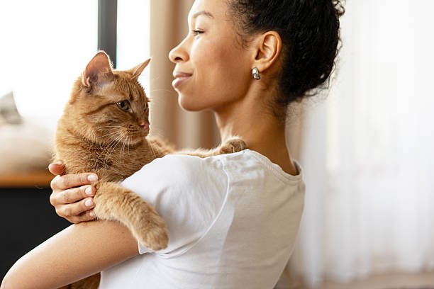 istock Young Woman Gently Holding Her Cat 2227652898
