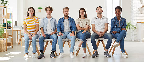 istock Group of diverse people sitting on chairs in row 2227653393
