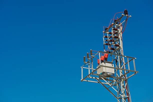 istock High voltage power transformer on blue sky with copy space. 2227655239