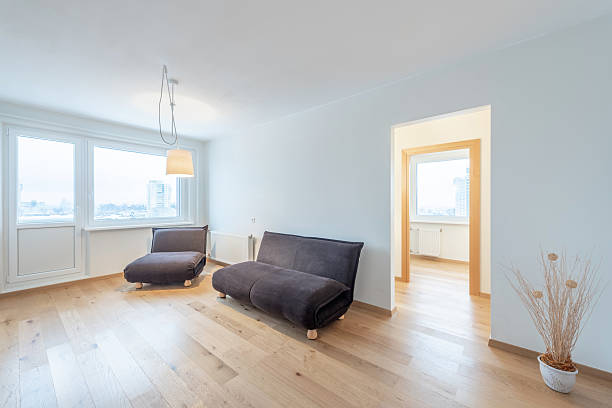 istock Minimalist Modern Home Living Room Interior with Large Windows and Cozy Seating 2227656911