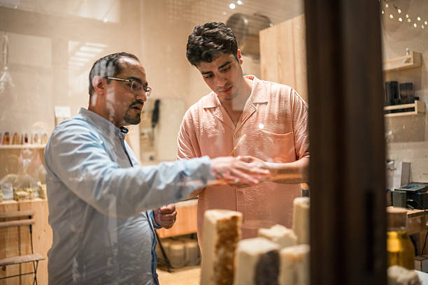 istock Middle Eastern Shopkeeper Explaining Traditional Soap Products To Young Customer In Local Store 2227657935