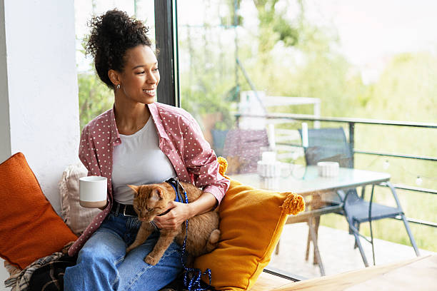 istock Young Woman Enjoying Coffee with Her Cat 2227659295