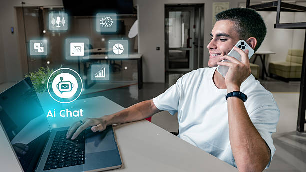 istock Young professional engages in AI chat while working on a laptop in a modern office environment 2227660642