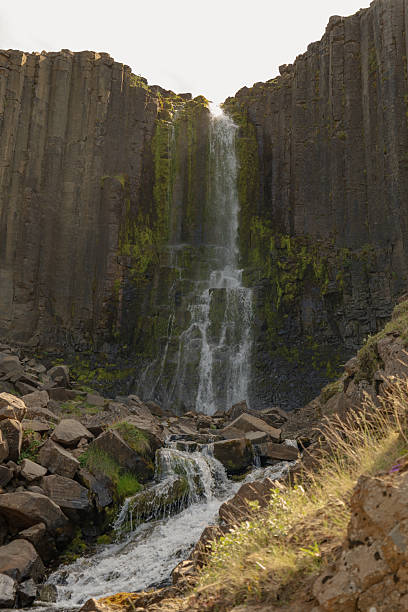 istock Waterfall Cascading Over Basalt Columns in Iceland's Rugged Landscape 2227661199