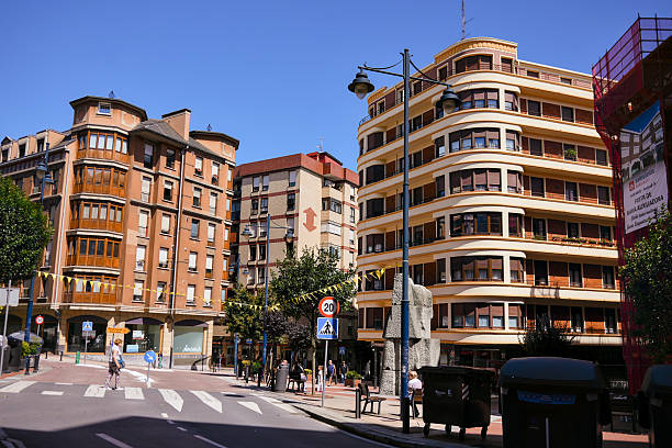 Residential buildings and street intersection with pedestrians and traffic signs in Barakaldo Spain on July 29 2025 Editorial use only