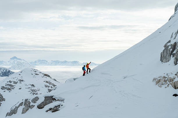 istock Two Climbers Ascending Snowy Mountain Slope in Winter Landscape 2227663796