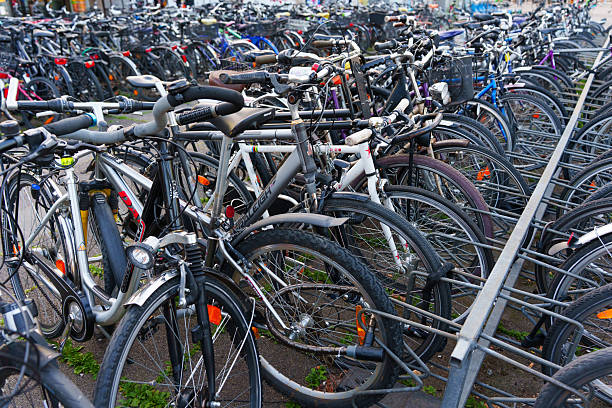 Heidelberg, Germany - June 21, 2025: Densely packed bicycle rack showing multiple bicycles parked in an urban setting during daylight.