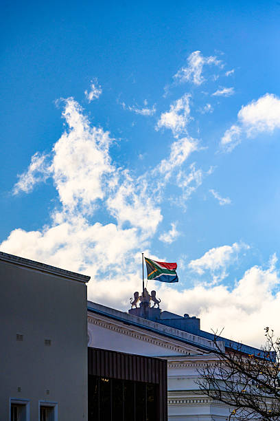 istock South African flag on historical building under a bright cloudy sky 2227668905