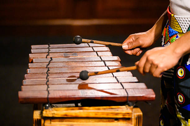 istock Hands playing a wooden percussion instrument in a traditional setting 2227668969