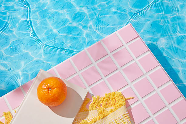 istock Clear turquoise water meets soft pink mosaic tiles, forming a sleek poolside layout with architectural appeal. A serene space perfect for placing product designs or natural beauty mockups. 2227669441