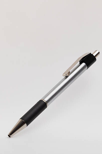 istock A silver and black ballpoint pen is depicted on a light background. The pen 2227672809