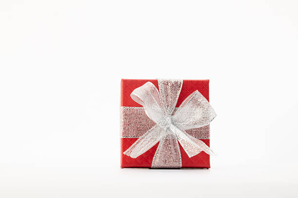 A red gift box with a silver ribbon tied in a bow is prominently displayed against a plain white background