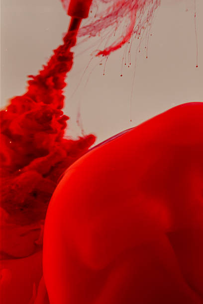 istock A vibrant red liquid spreads and disperses within a lighter, possibly clear, medium, 2227676134