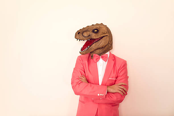 istock Funny man in dinosaur mask on studio background 2227676476