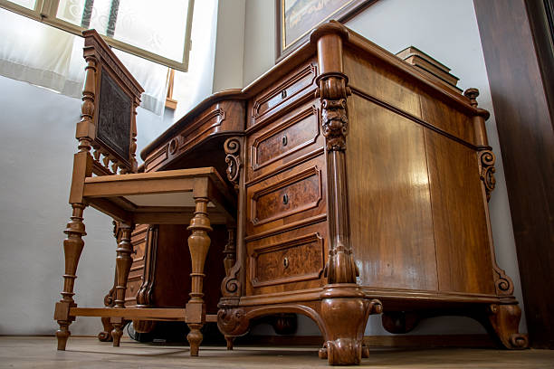 istock The old wooden table with seat, look from below. Historical office with table. 2227676568
