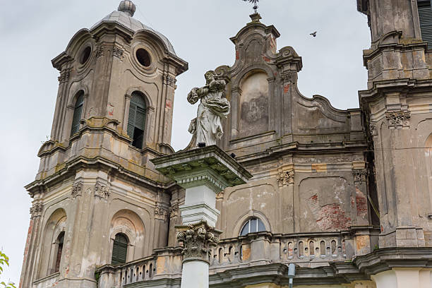 Column with Virgin Mary statue against Church of Immaculate Conception