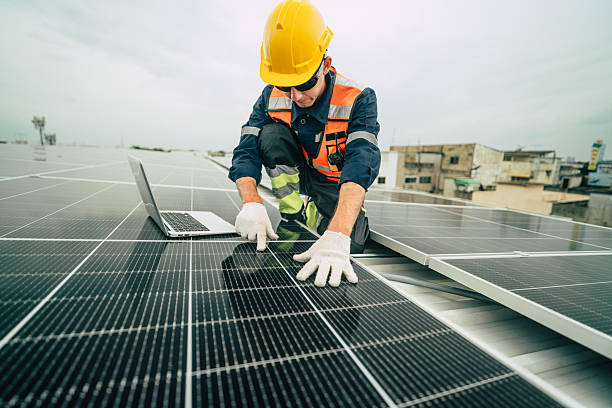 istock Technician performs maintenance on solar panels at an urban rooftop during a cloudy day 2227677645