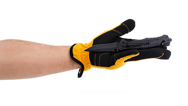 istock Hand holding knife with protective glove shown 2227678029
