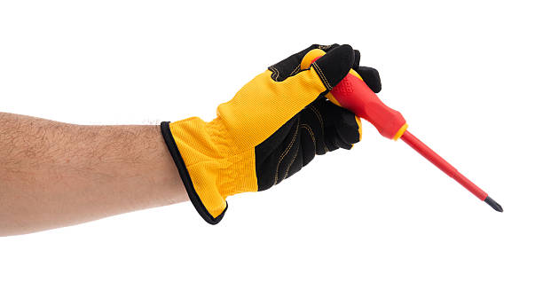 istock Hand holding screwdriver while wearing gloves 2227678056