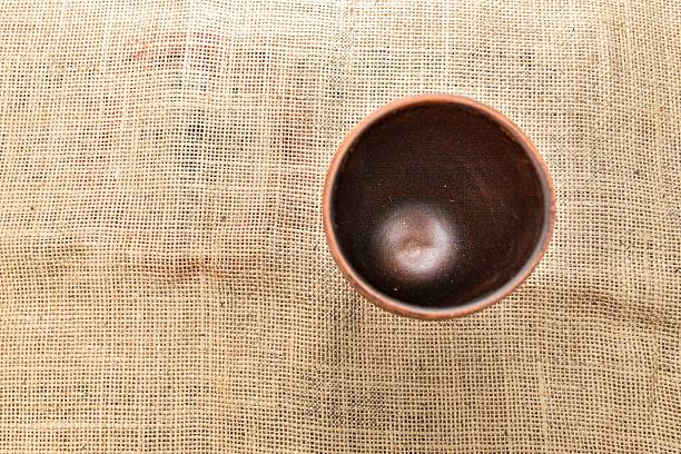 Creative coffee cup with funny eye on a orange background