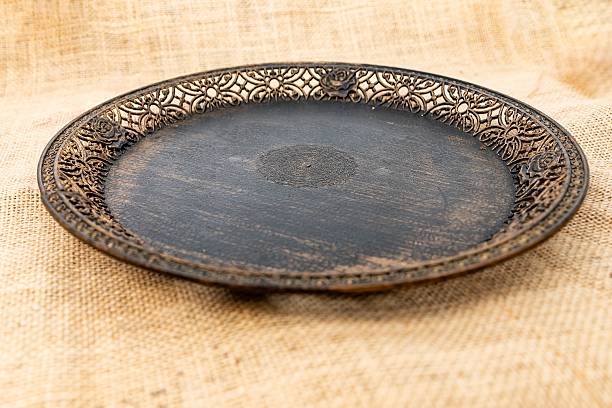 istock Vintage black decorative plate on burlap background, top view 2227679208