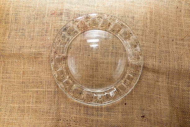 istock Top view of clear glass plate on burlap rustic background 2227679249