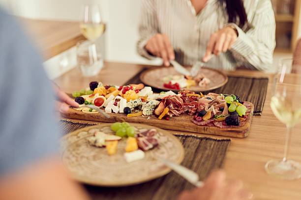 istock Charcuterie Board with Plates and Wine at a Dinner Table 2227679827