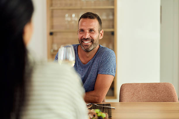 istock Smiling Man Enjoying a Meal While Relaxing in a Bright Modern Interior 2227679838