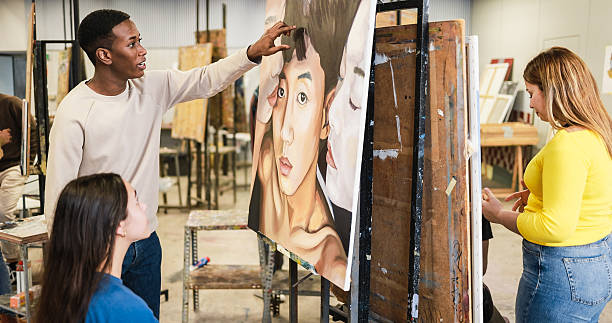 istock Students describing an art paint during university class - Back to school and campus lifestyle concept - Soft focus on african boy face 2227681292