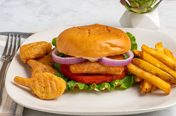 istock fish sandwich  with  lettuce, tomato and onions 2227682433