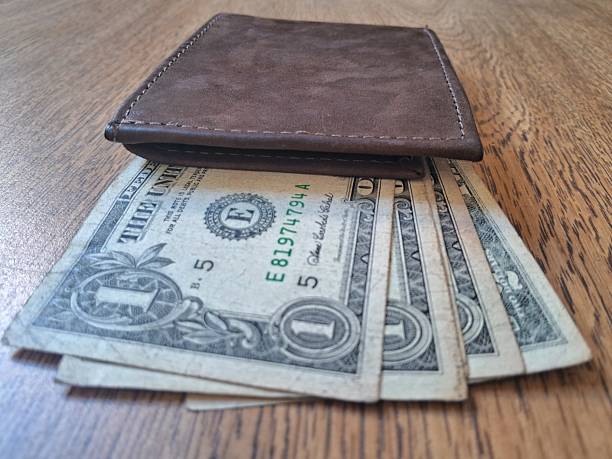 istock US dollar bills inside a leather wallet on a wooden background 2227683142
