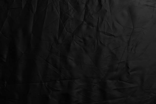 istock Black crumpled material surface of dark synthetic fabric 2227684664