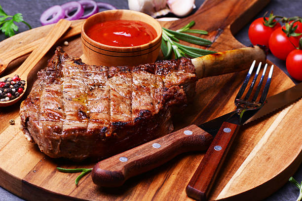 istock Tomahawk steak with spices and vegetables 2227694185