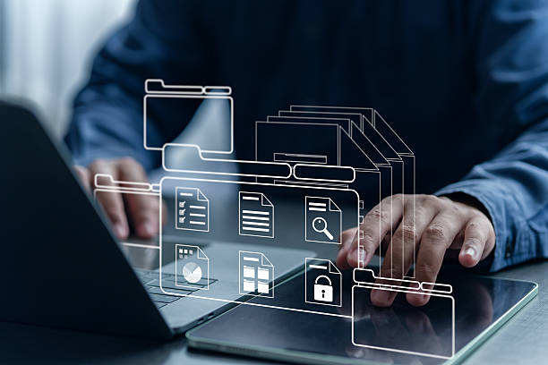 istock Digital file and folder organization system with businessman using laptop to manage structured documents in a virtual office environment. 2227697051