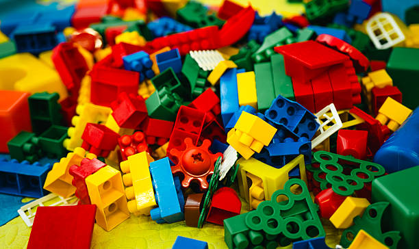 Colorful building blocks scattered on a bright play mat, creating a playful atmosphere in a children's playroom.