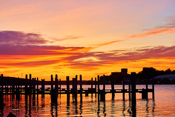 Breathtaking Autumn Sunrise Over Calm Waterfront with Empty Dock in Houghton, Michigan