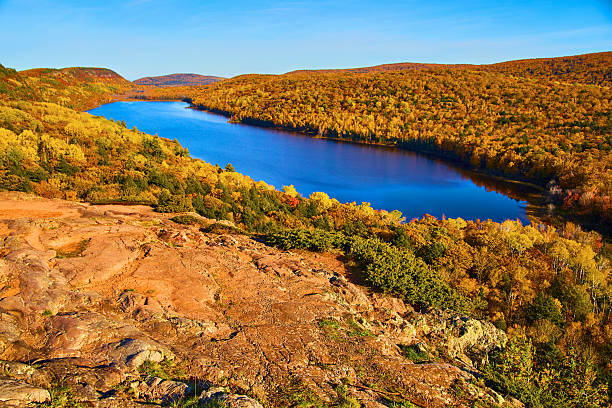 istock Autumn Splendor in Ontonagon - Vibrant Fall Foliage and Serene River View 2227703088