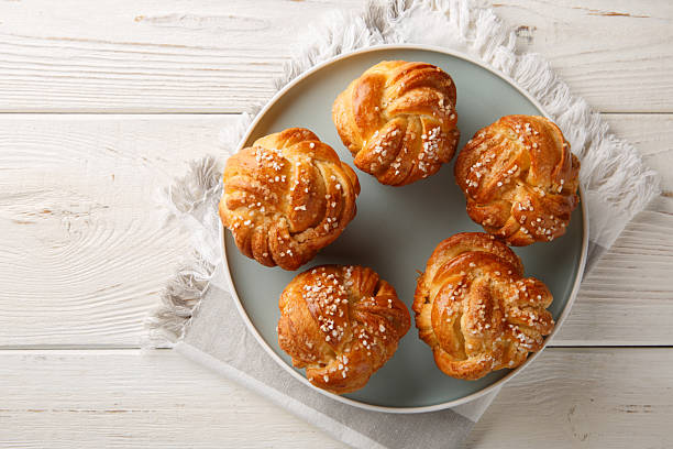 Yeast Knot Sugar Buns with Vanilla Close-up in Plate. Horizontal top view stock photo