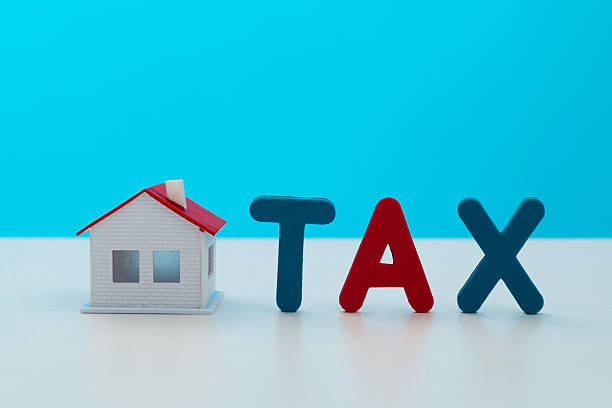 istock Model house and word TAX 2227705997
