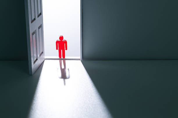 People figurine standing in front of open door